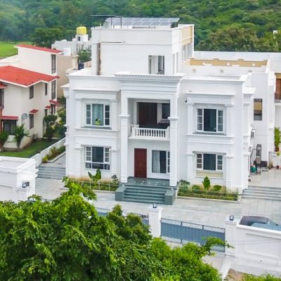 Aerial view of Chez Lavania — hotels in Udaipur near Lake Pichola with Aravali hills and Monsoon Palace